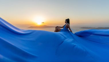 Blue flying dress sunset photoshoot in Santorini, Greece
