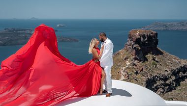 Santorini red flying dress photoshoot on a white roof