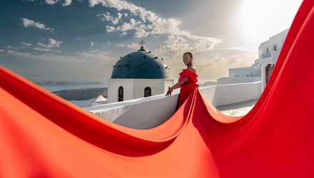 Sunset flying dress photoshoot by the blue dome in Imerovigli