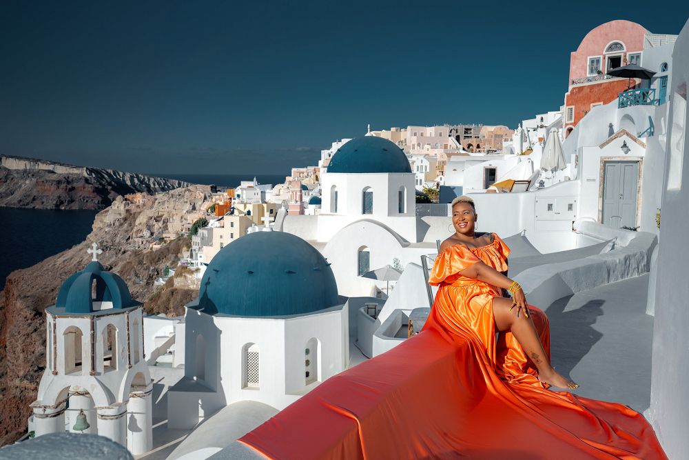 Blue domes photoshoot with a flying Santorini dress