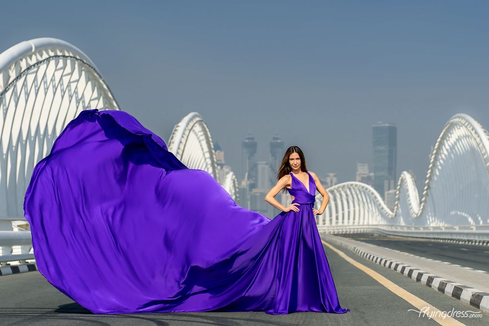 Elevate elegance on Dubai's Meydan Bridge with our model's mesmerizing flying dress photoshoot.
