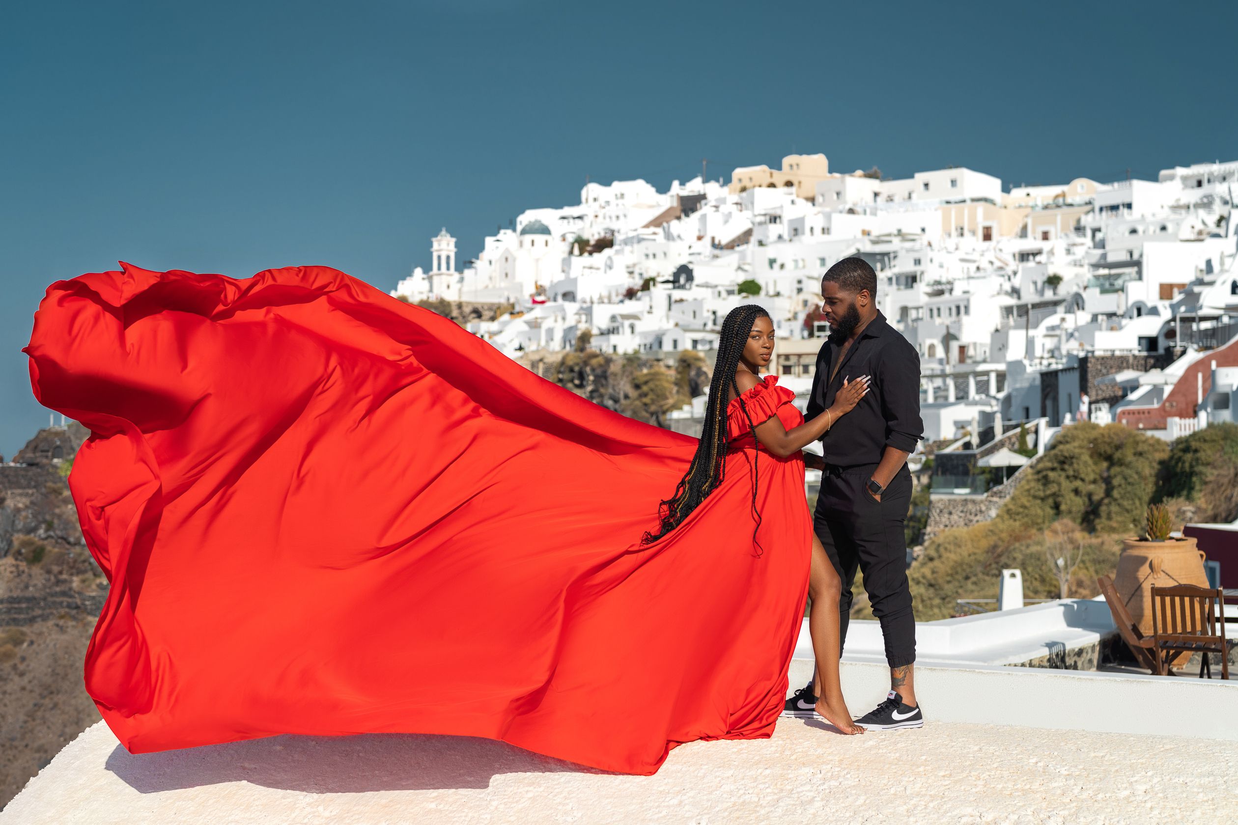 Red Santorini flying dress couple photoshoot in Imerovigli, Greece