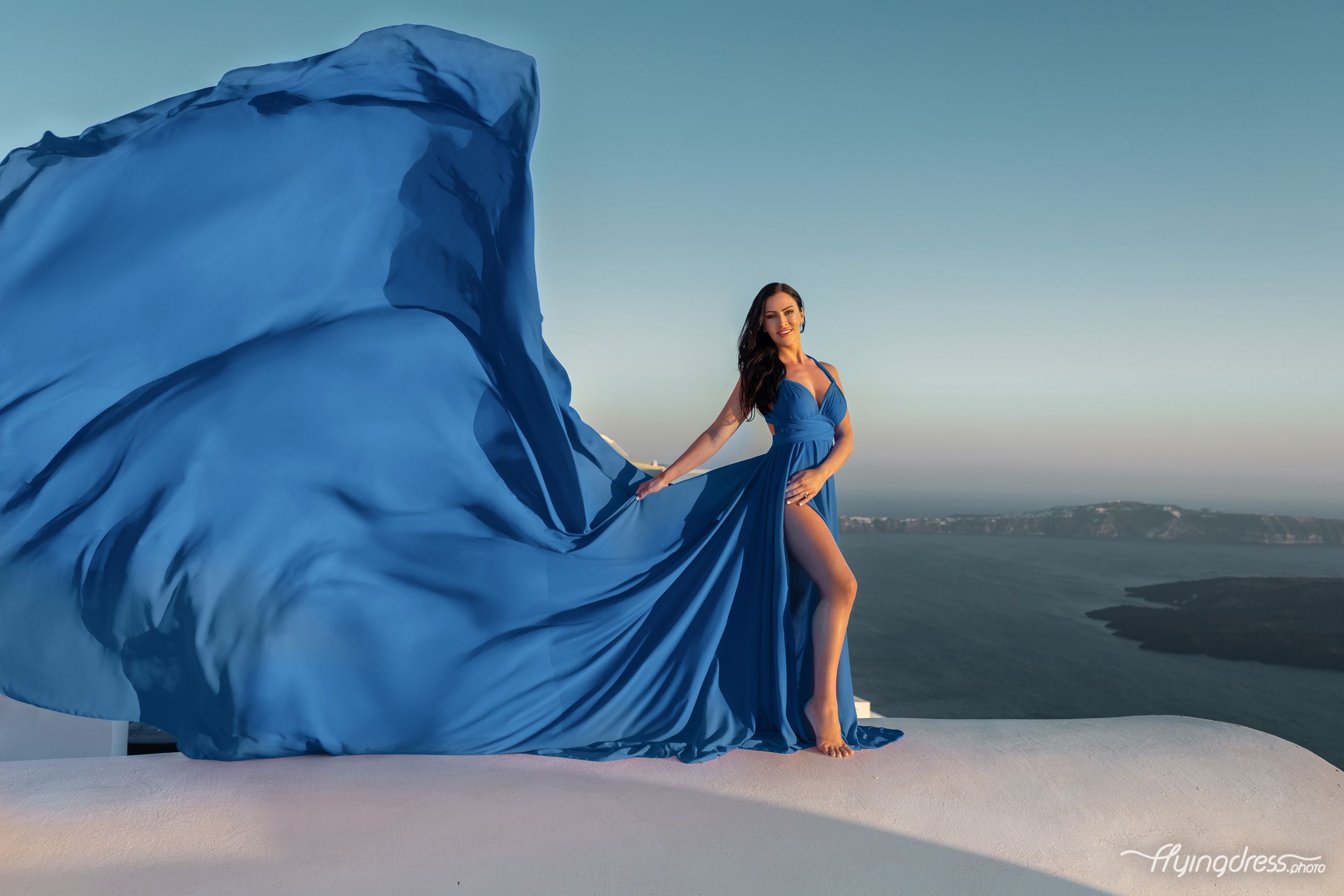 Blue flying transformer dress photoshoot in Santorini