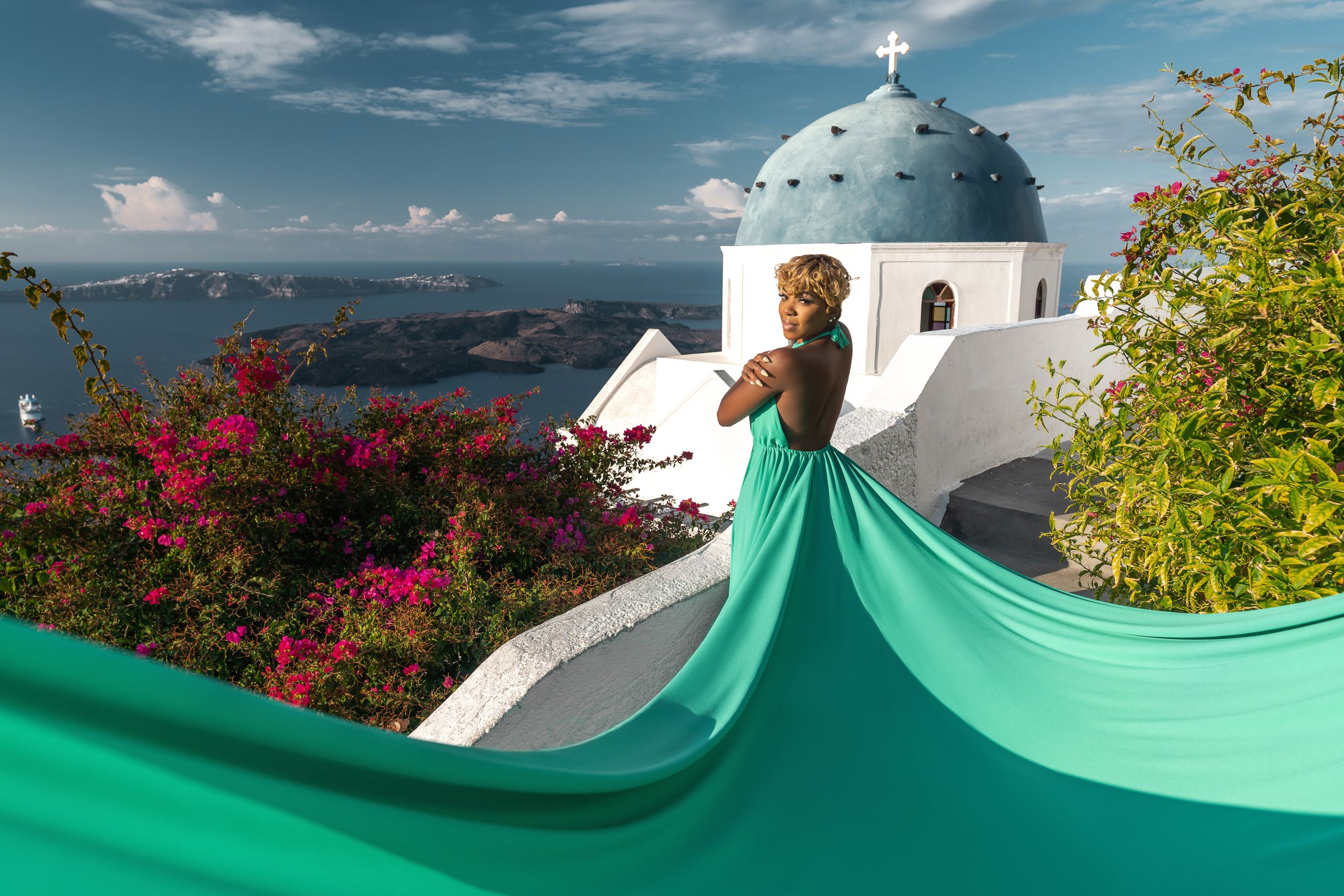 Photoshoot with a green flying dress in Imerovigli, Greece