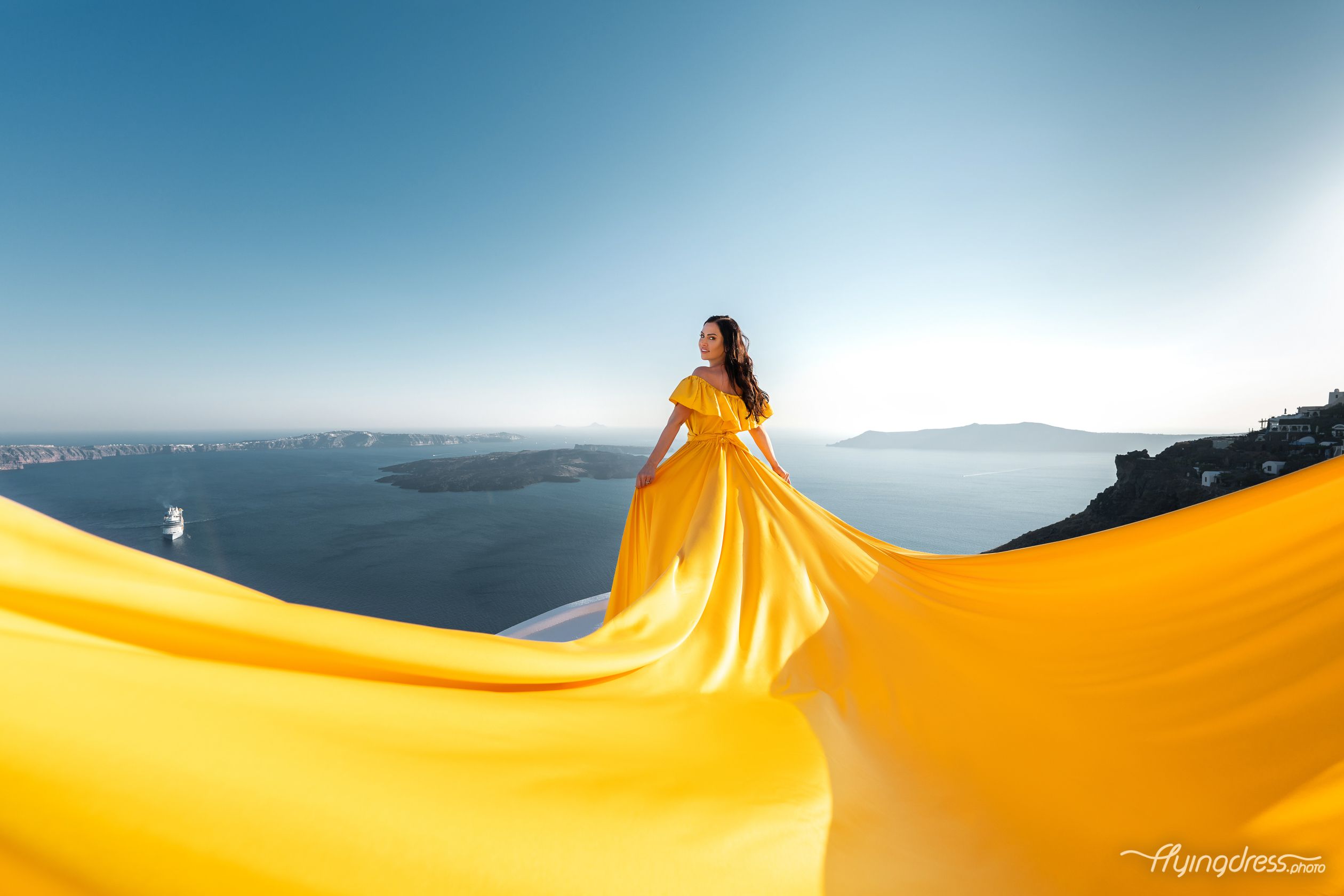 Flying Santorini dress photoshoot with a yellow dress