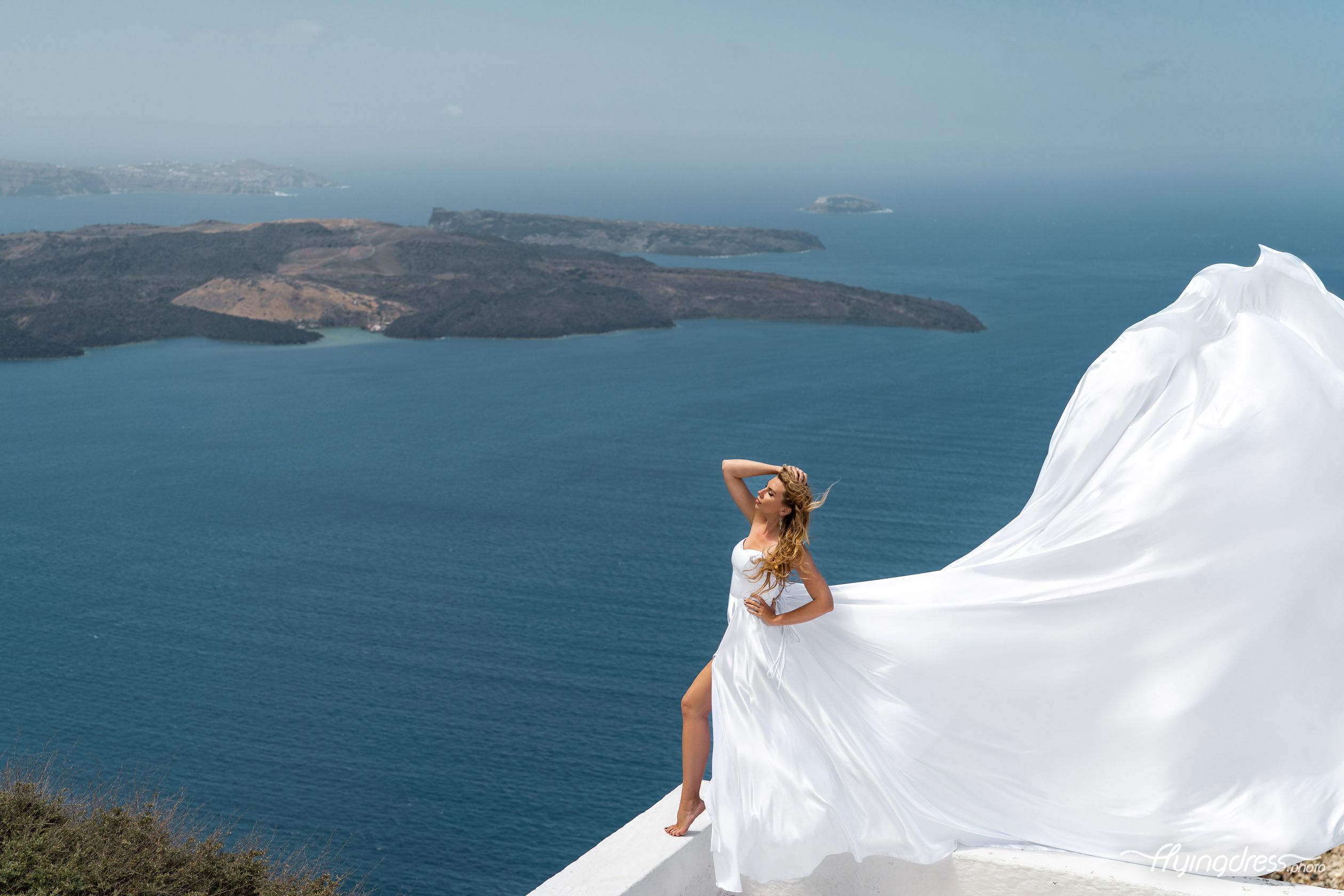 Photoshoot with a white flying corset dress and the volcano at the background