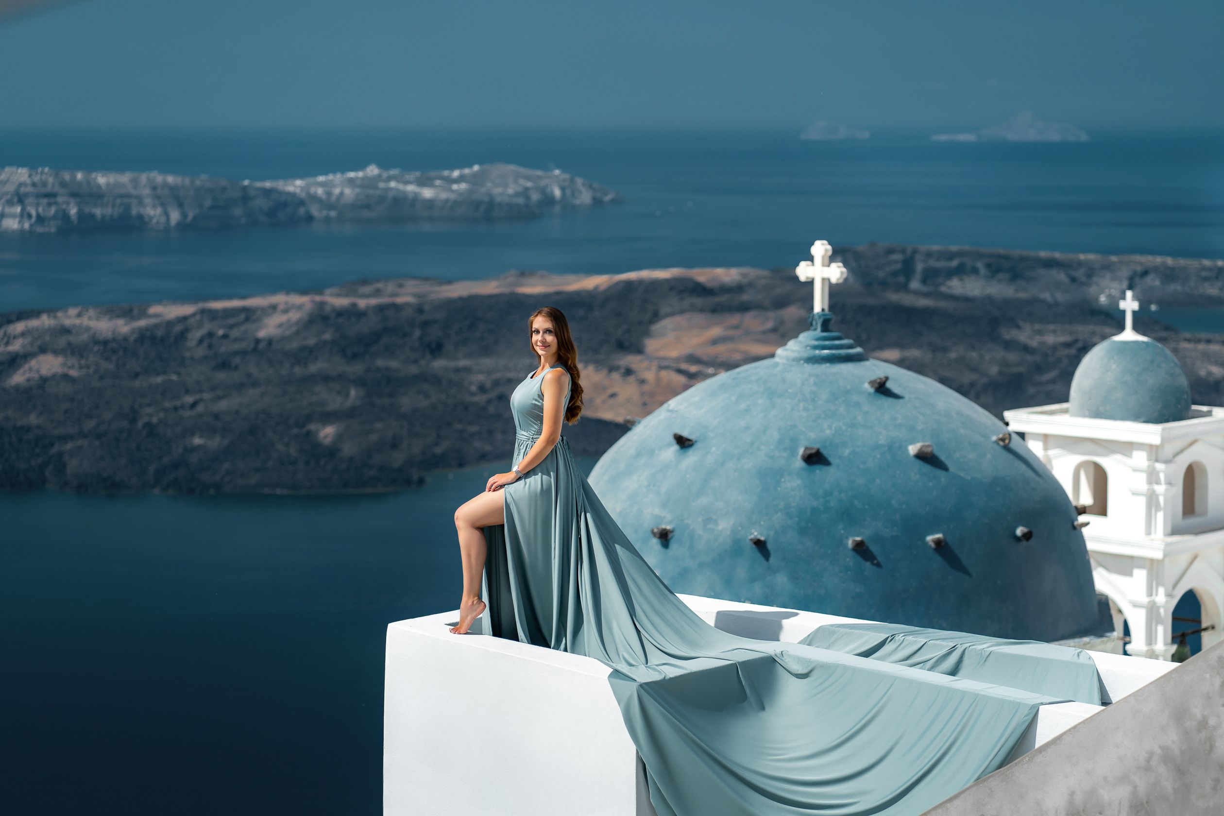 Santorini flying dress photoshoot with blue domes