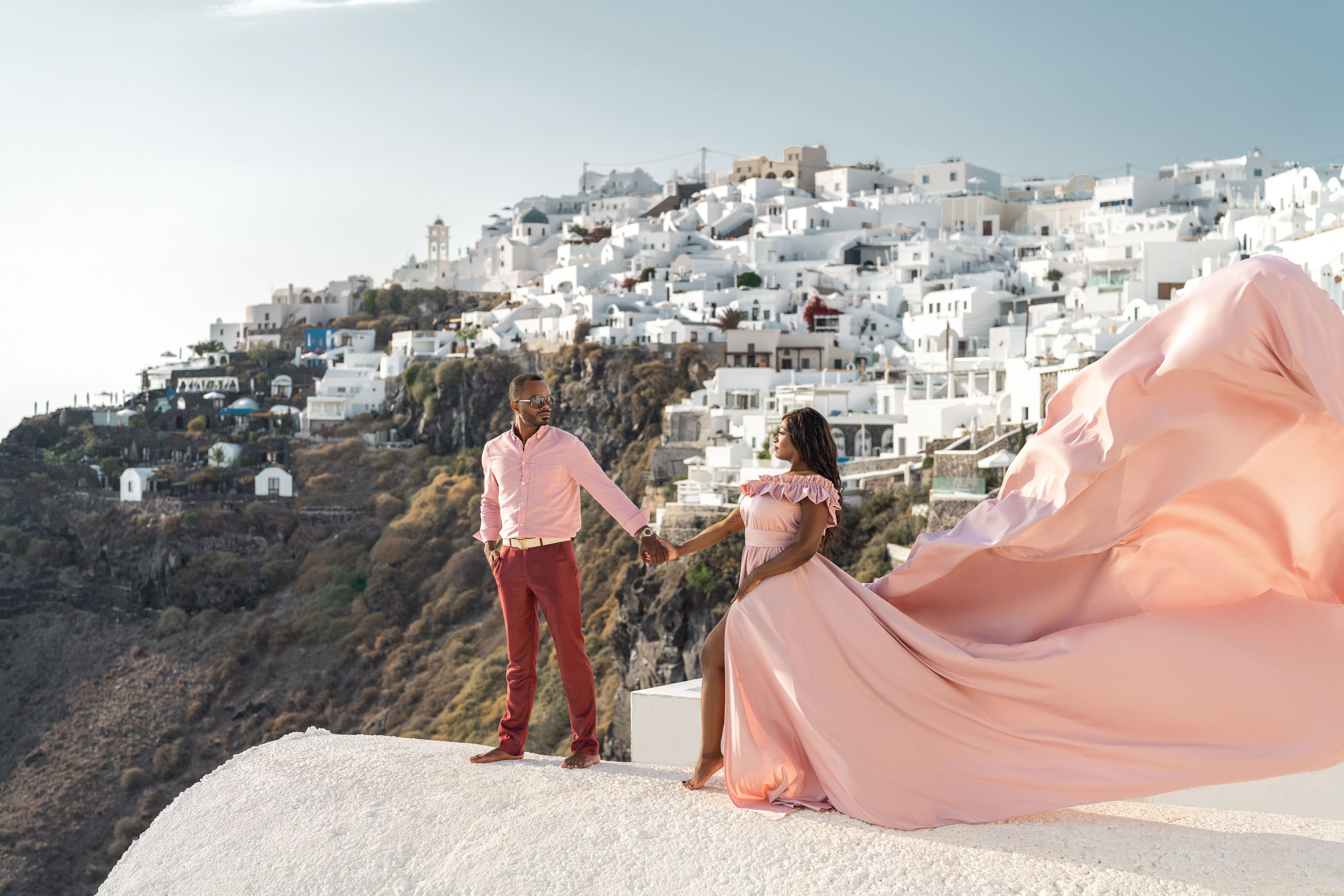 Couple photoshoot in Imerovigli, Greece with a flying dress