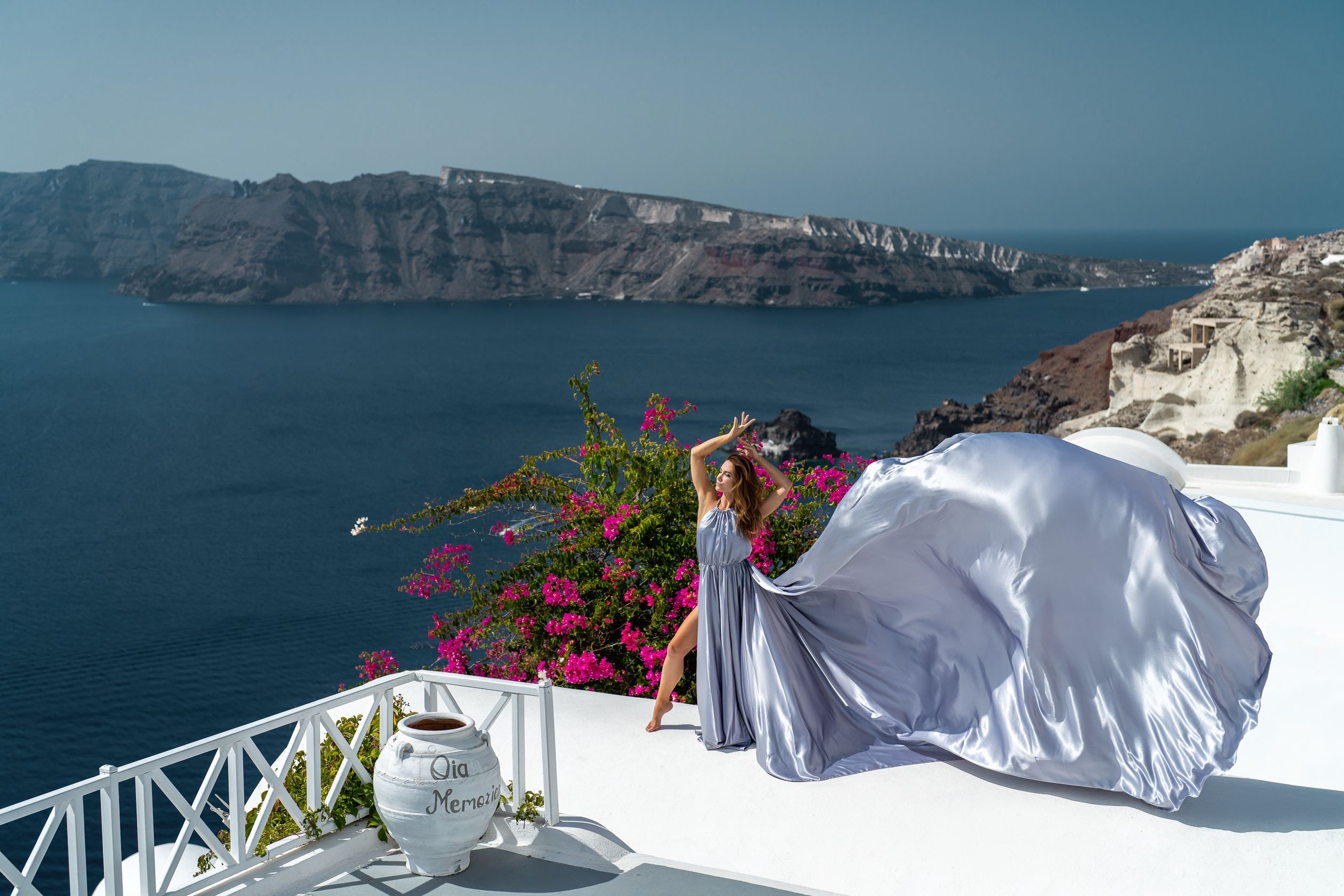 Flying dress photoshoot in Oia village
