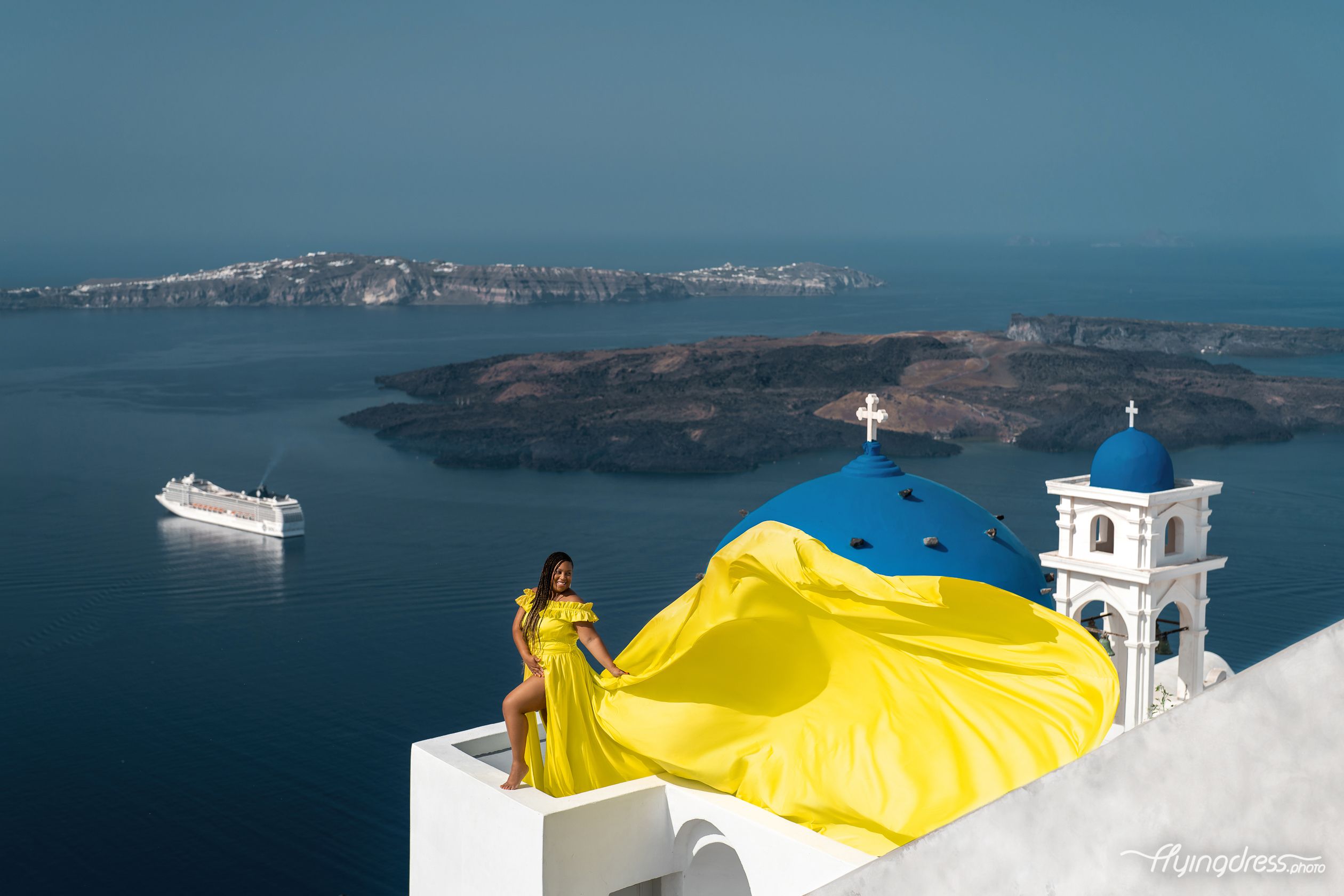 Santorini neon flying dress photoshoot by the blue domes