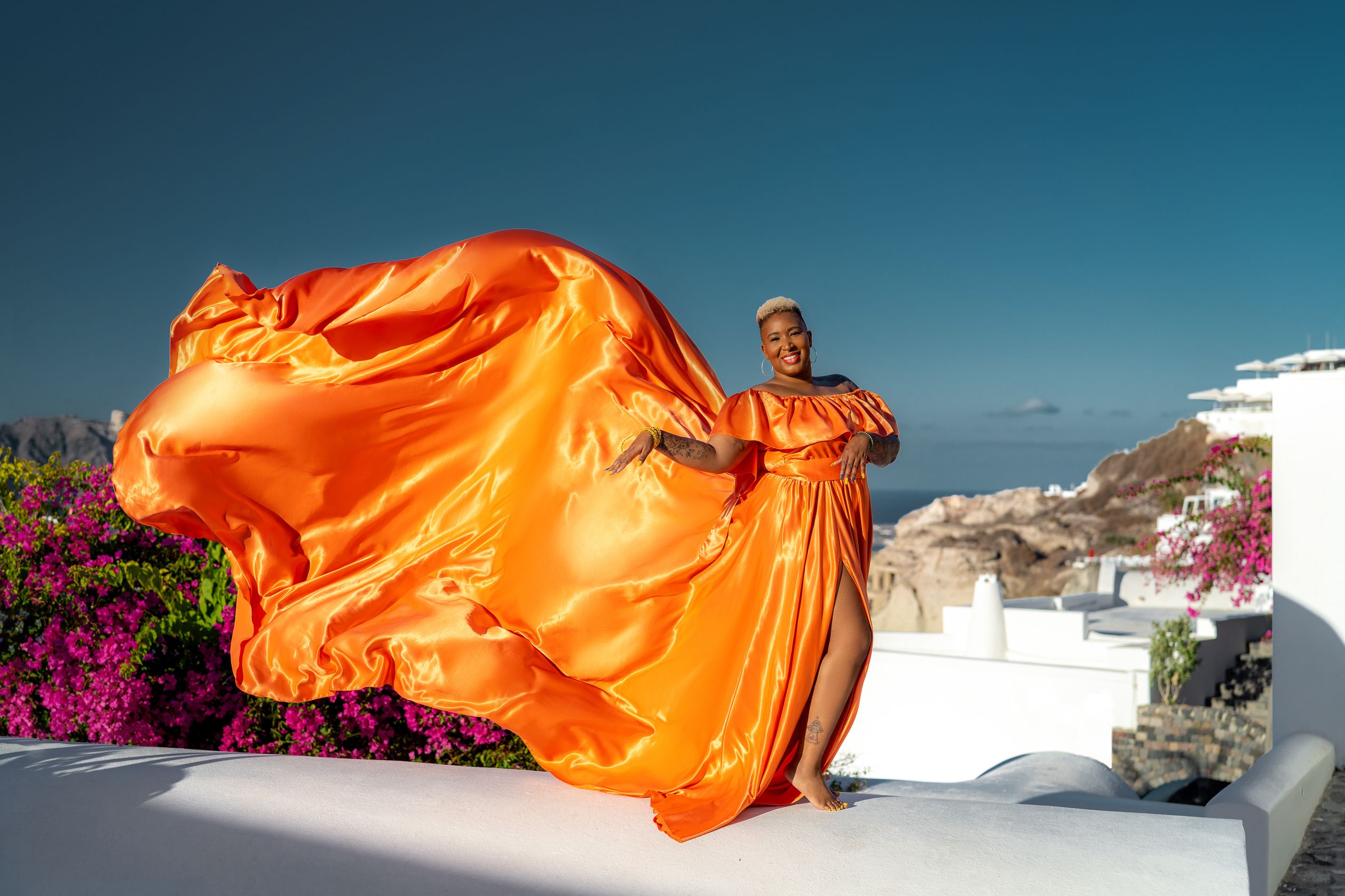 Orange flying dress photoshoot in Santorini