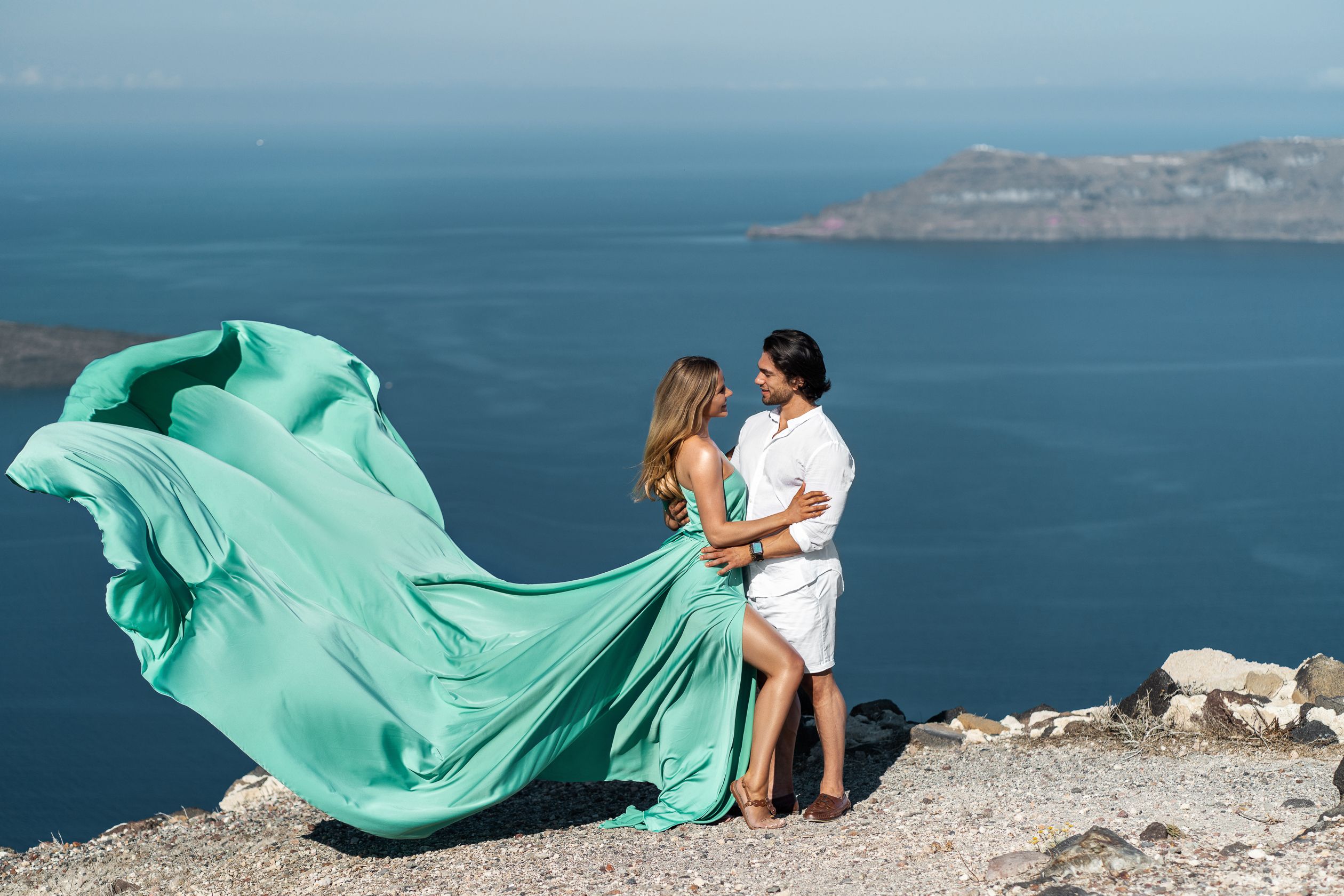 Couple flying Santorini dress shoot in Imerovigli, Greece
