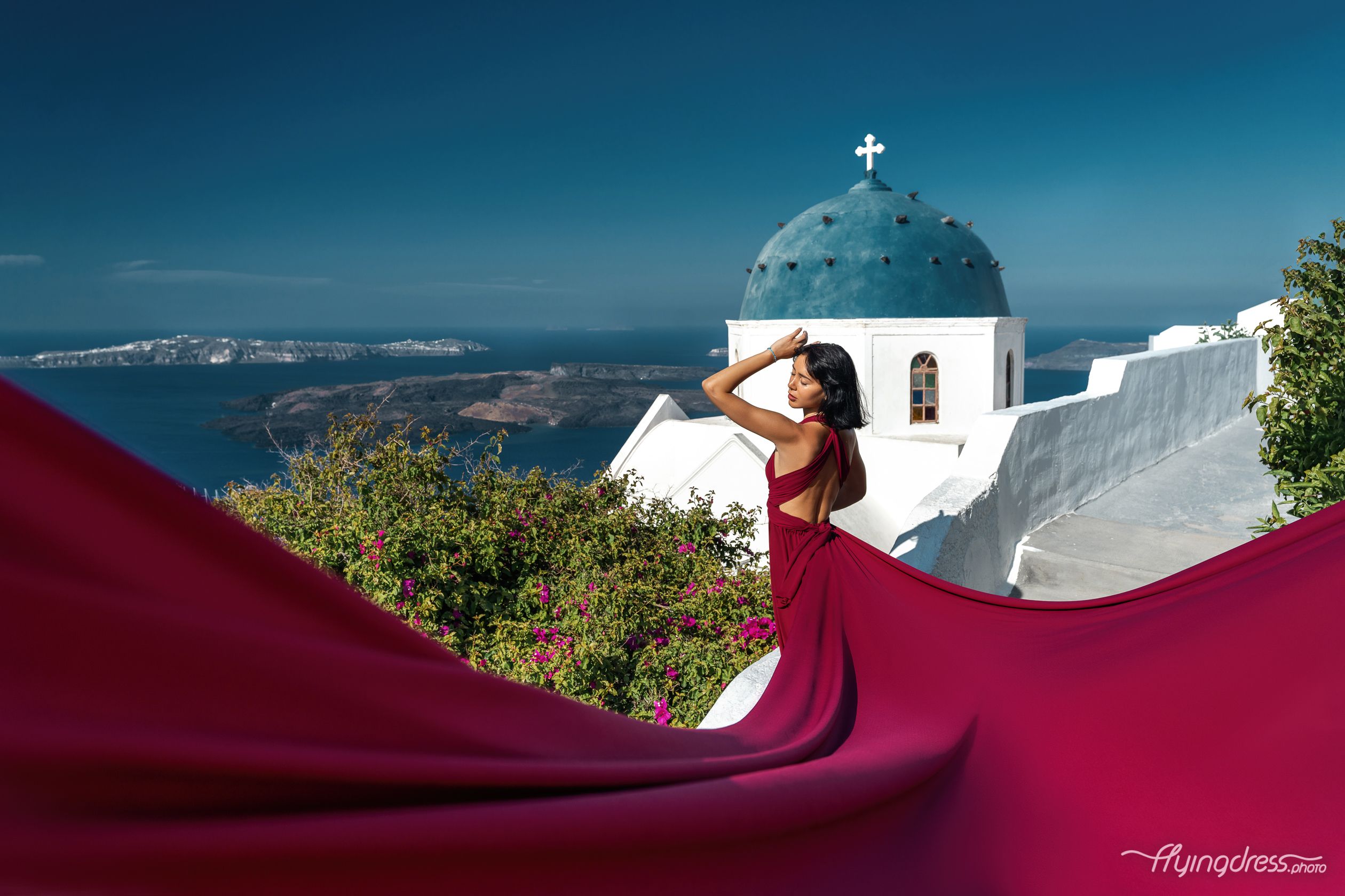 Flying Santorini dress photoshoot by the blue domes in Imerovigli with Eva Fouska