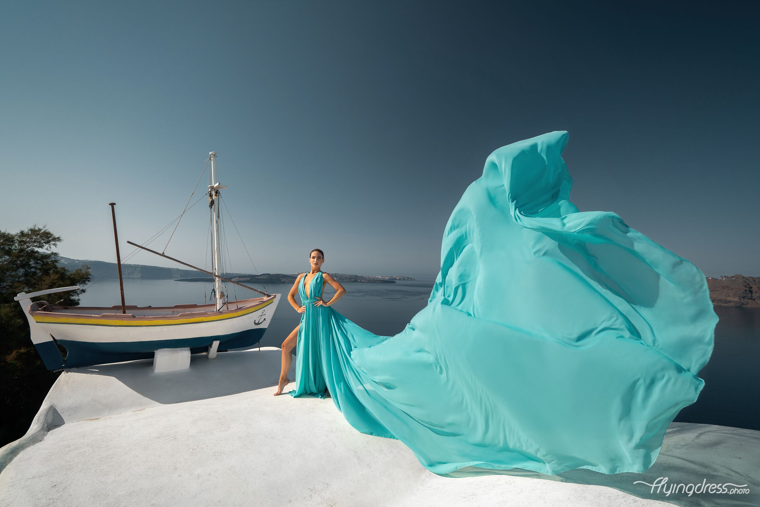 Photoshoot in Oia village with a tiffany blue flying dress