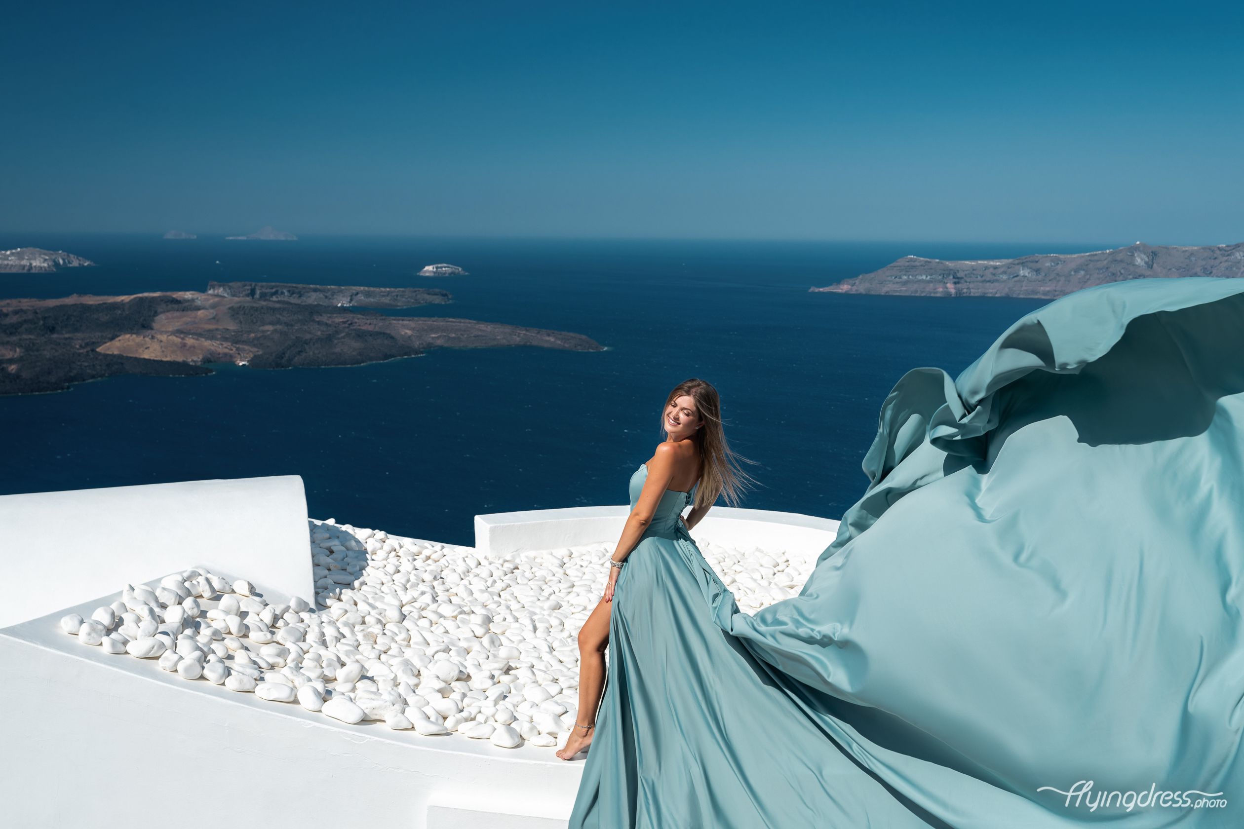 Santorini flying dress photoshoot with caldera view