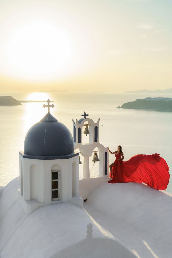 Sunset red flying dress photo in Santorini