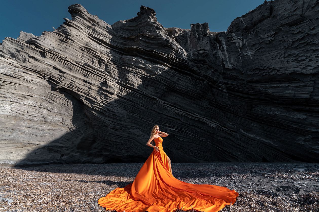 Flying dress photoshoot at the black beach of Columbus in Santorini