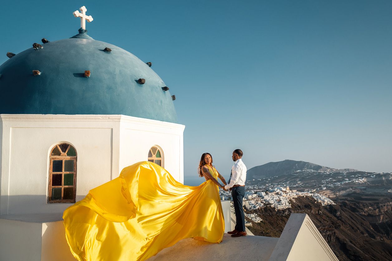 Imerovigli blue dome photoshoot with a flying dress