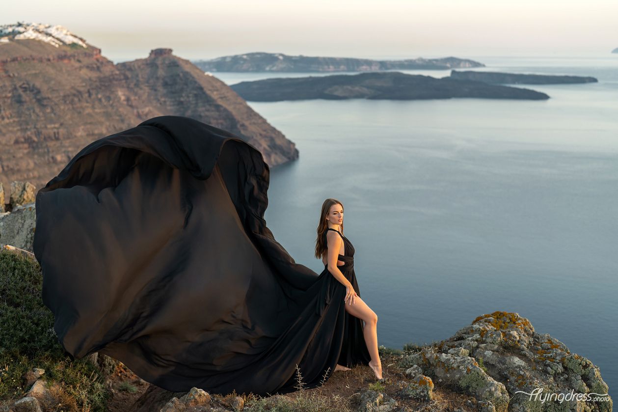 Sunset photoshoot with a flying dress in Santorini