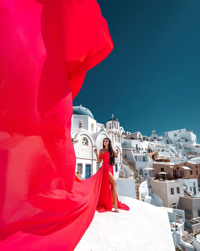 Blue domes and white houses - photoshoot with a flying Santorini dress
