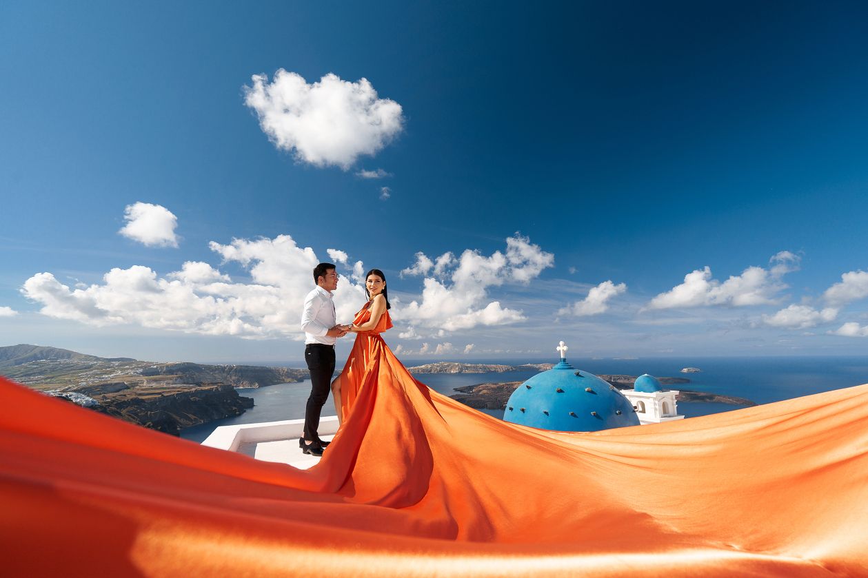 Orange flying Santorini dress blue dome photoshoot