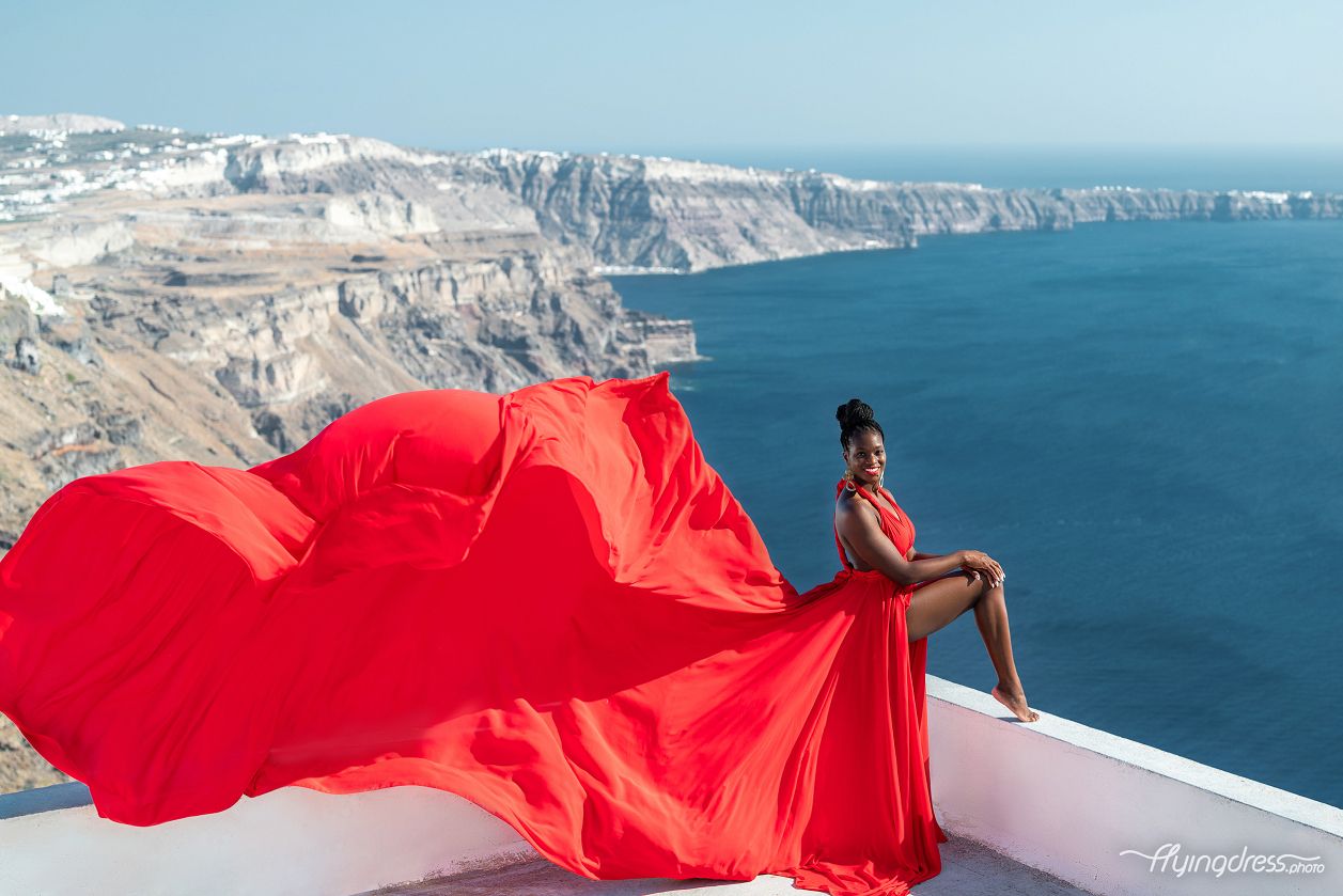Flying dress photoshoot in Santorini with caldera view