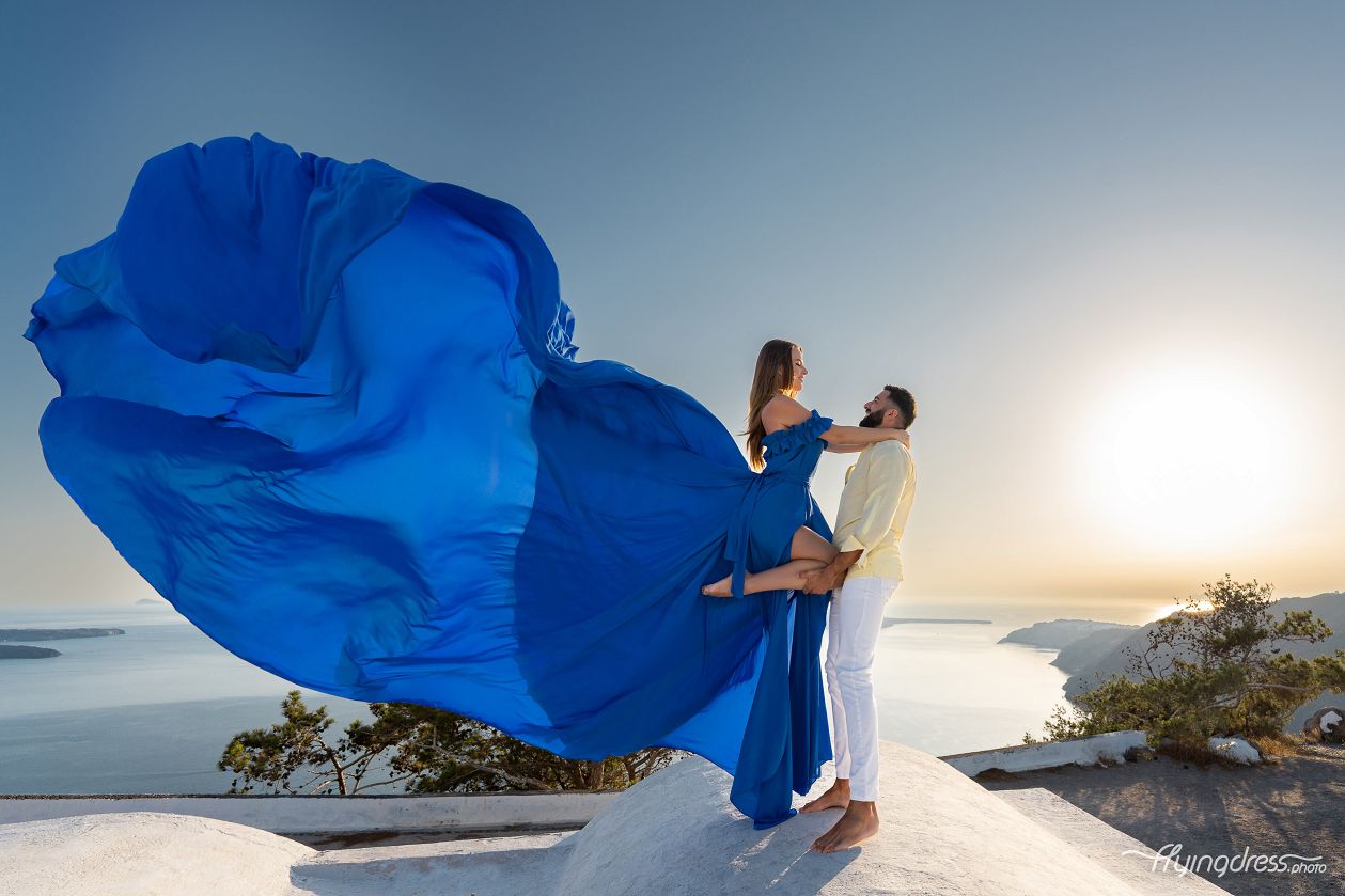 Couple photoshoot with a blue flying dress in Santorini