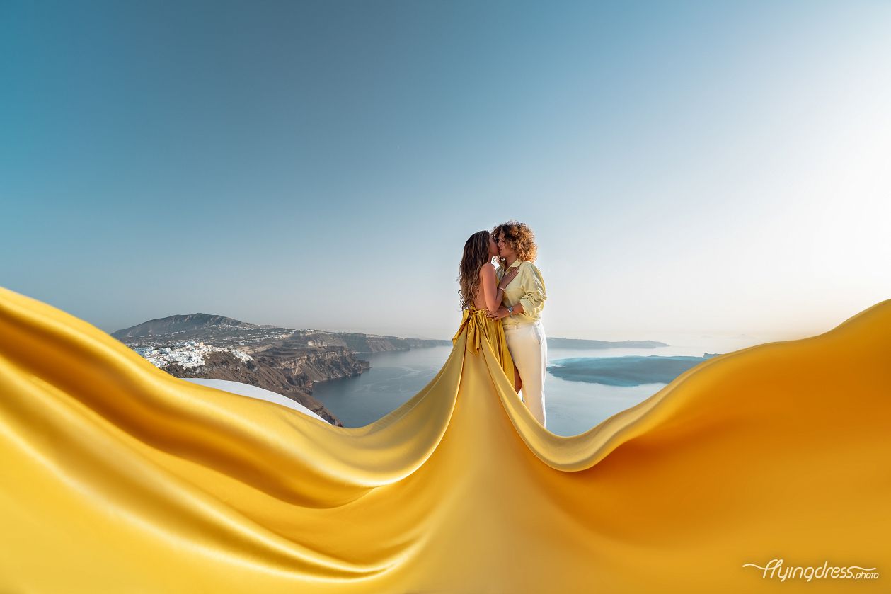 A lesbian couple doing Santorini dress photoshoot