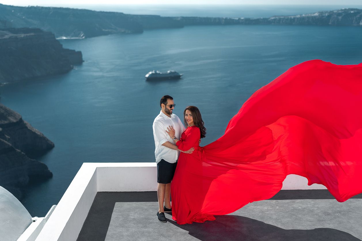 Long sleeve red flying dress couple photoshoot in Santorini