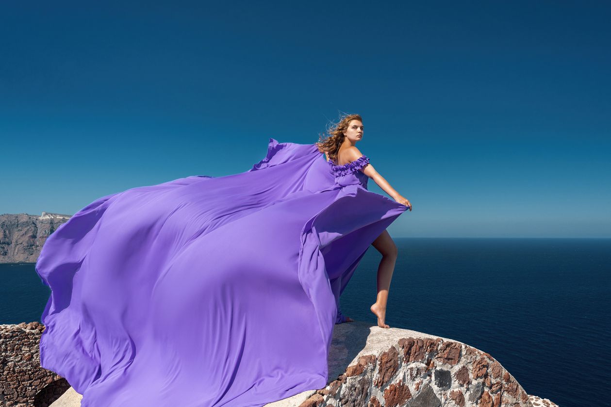Flying dress photoshoot at the castle of Oia, Santorini