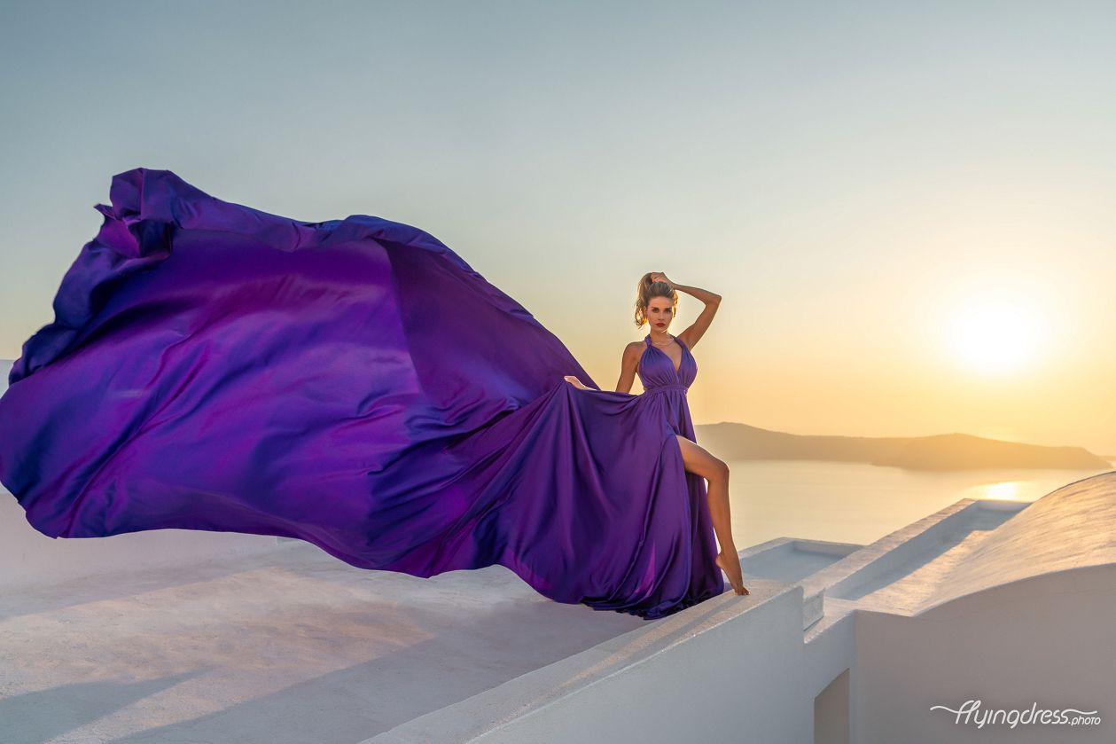 Sunset photoshoot in Santorini with a flying dress