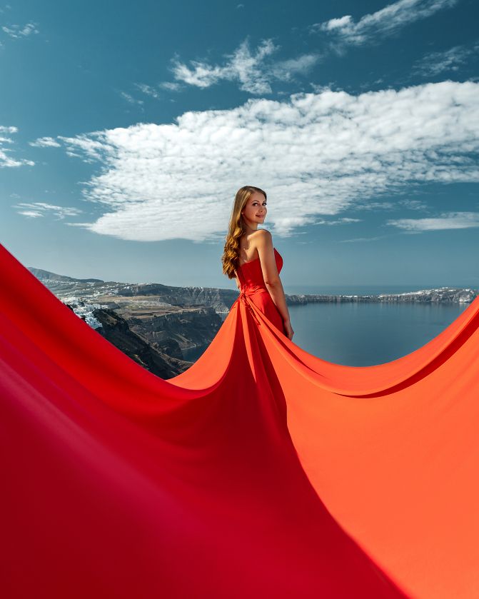 Red flying dress photoshoot in Santorini