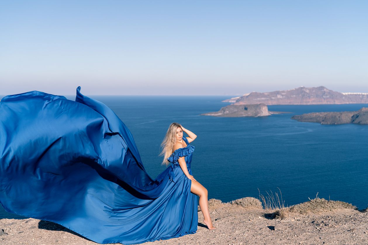 Santorini flying dress photoshoot with caldera and volcano view