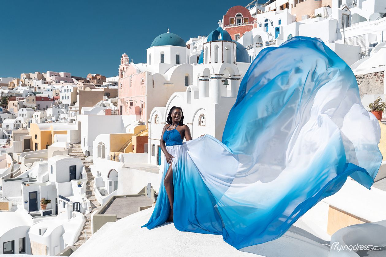 Flying Santorini dress photoshoot by the blue domes
