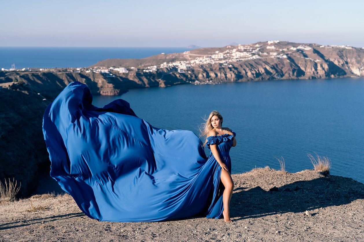 Royal blue satin flying dress shoot in Megalochori, Santorini