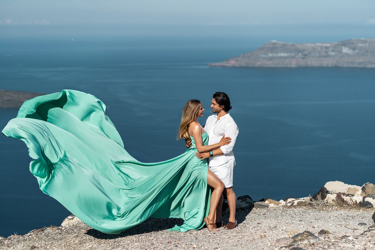 Couple flying Santorini dress shoot in Imerovigli, Greece