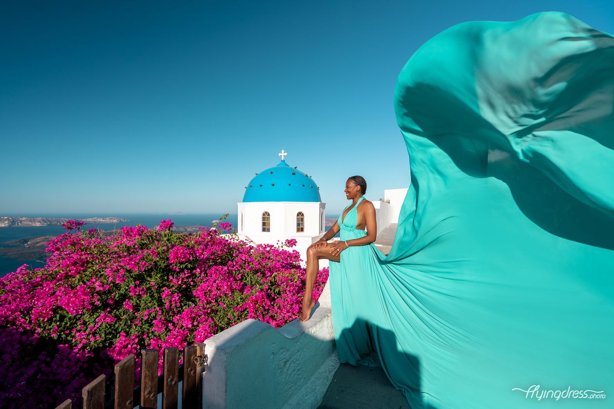 Flying dress photoshoot by the blue dome in Santorini