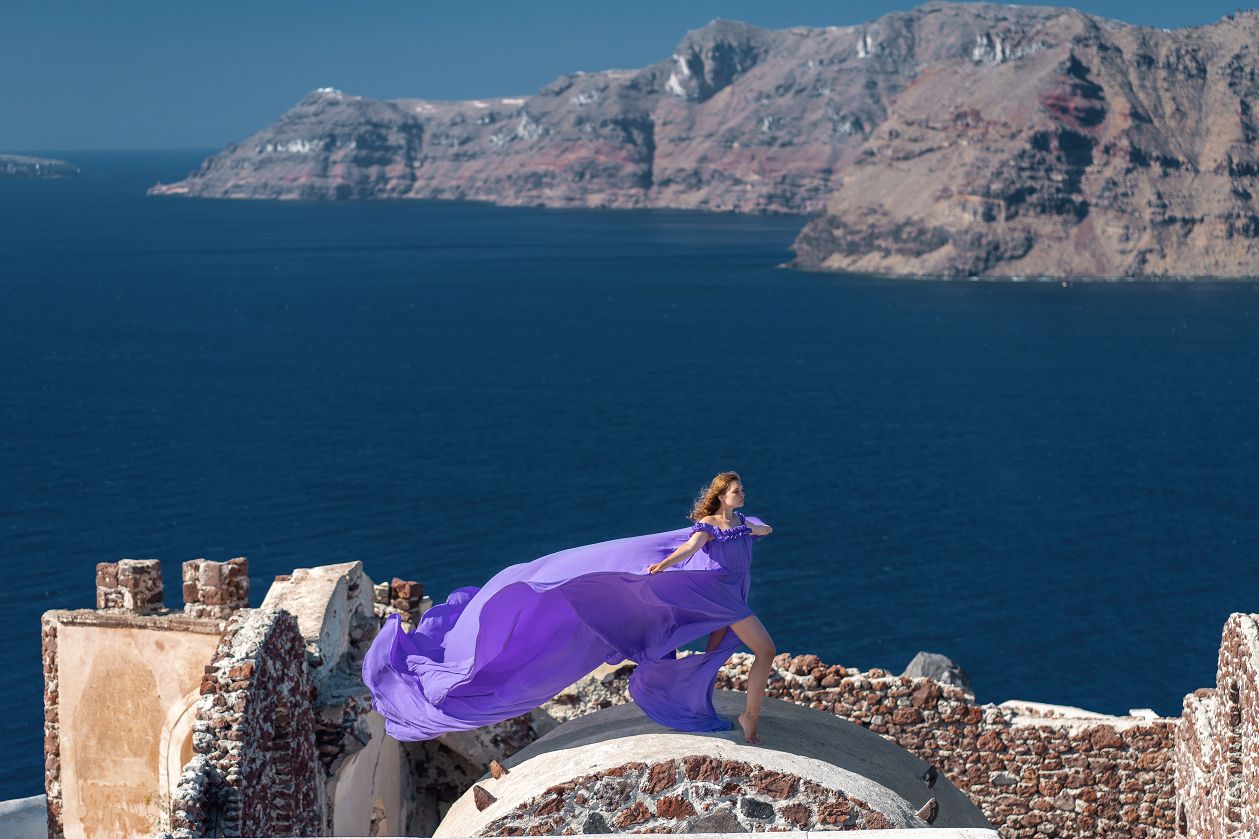Flying dress photoshoot at the castle of Saint Nicolas in Oia, Santorini
