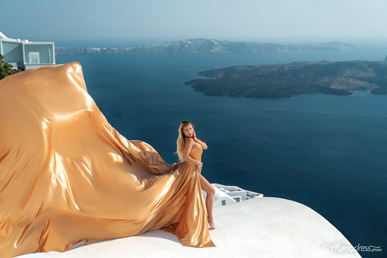Flying Santorini dress photoshoot with a gold corset dress