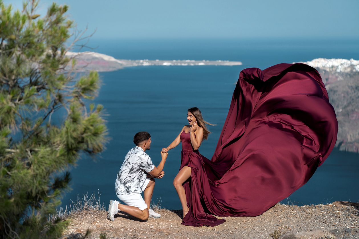 Proposal photoshoot in Santorini with a flying dress
