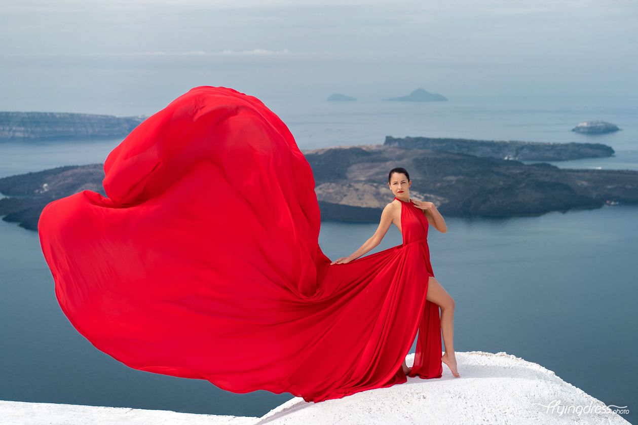 Iconic red flying dress photoshoot with caldera view in Santorini