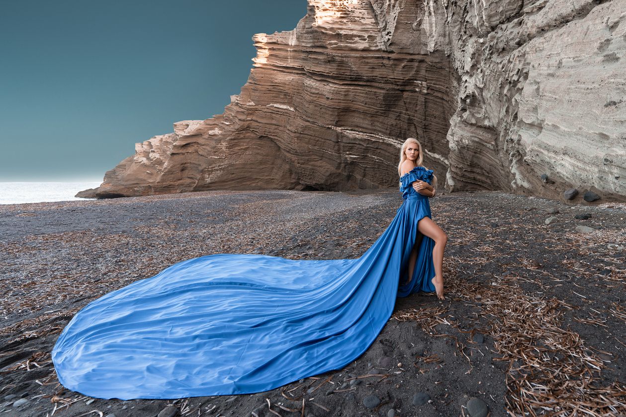Royal blue Santorini flying dress photoshoot at the black beach