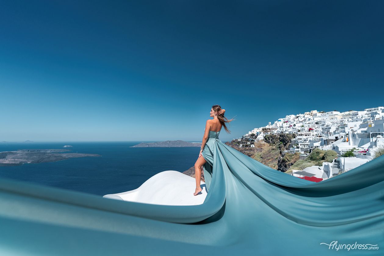 Flying Santorini dress photoshoot with white houses
