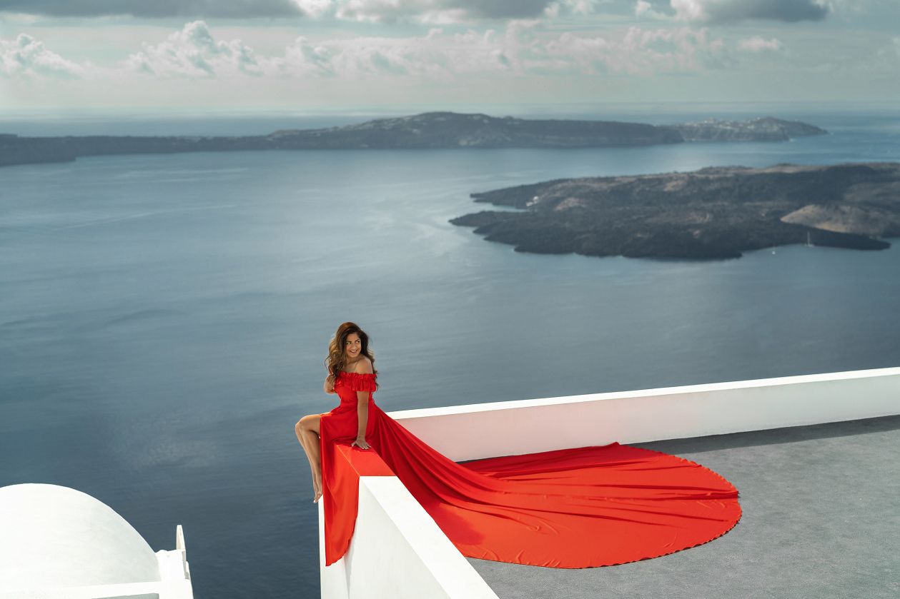 Santorini flying dress photoshoot with volcano and caldera view