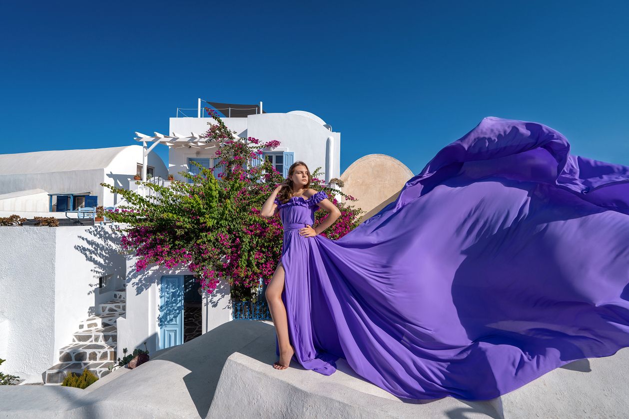 Photoshoot in Oia village with a purple flying dress
