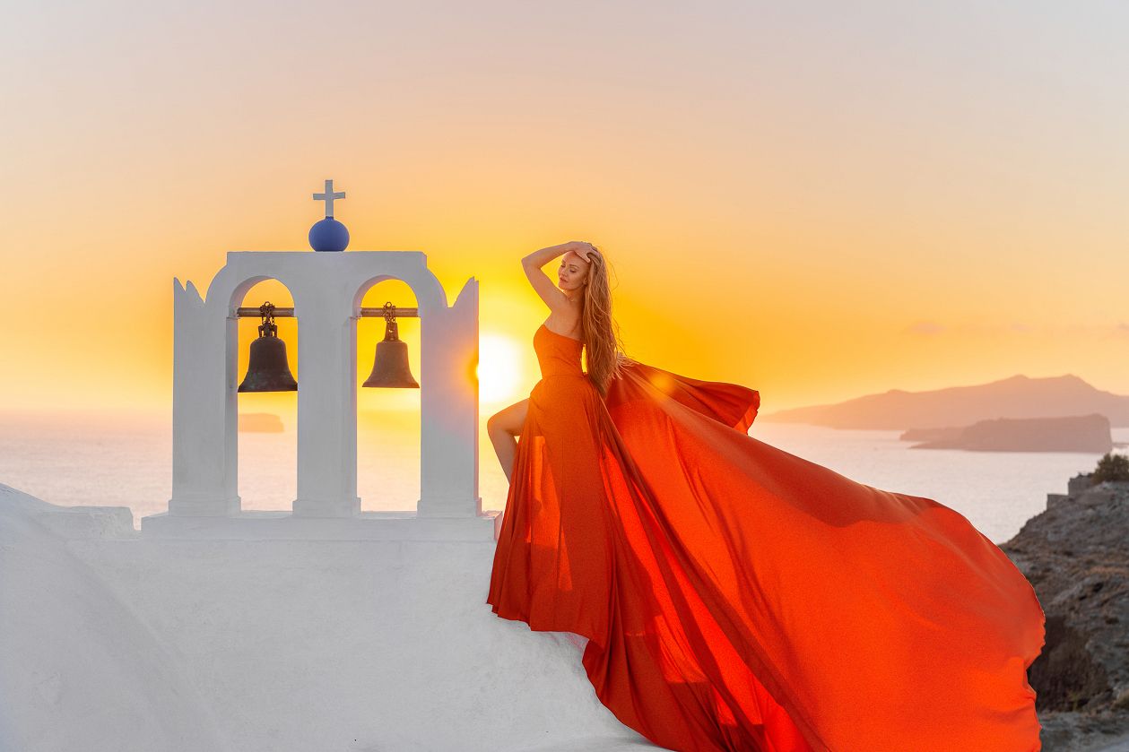 Sunset photoshoot with an orange flying dress