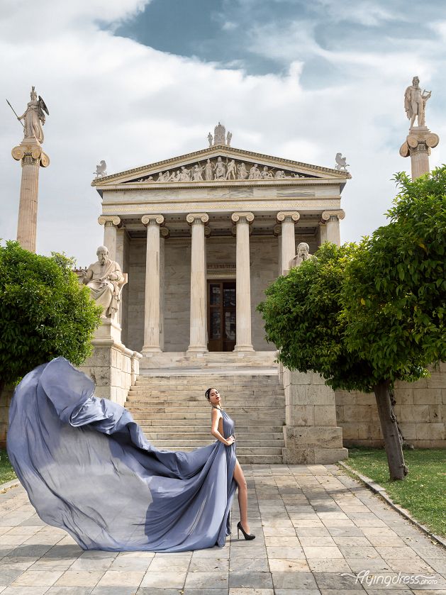 Radiating elegance in a shimmering silver dress, a model captivates against the backdrop of timeless beauty, creating a stunning visual tableau in Athens
