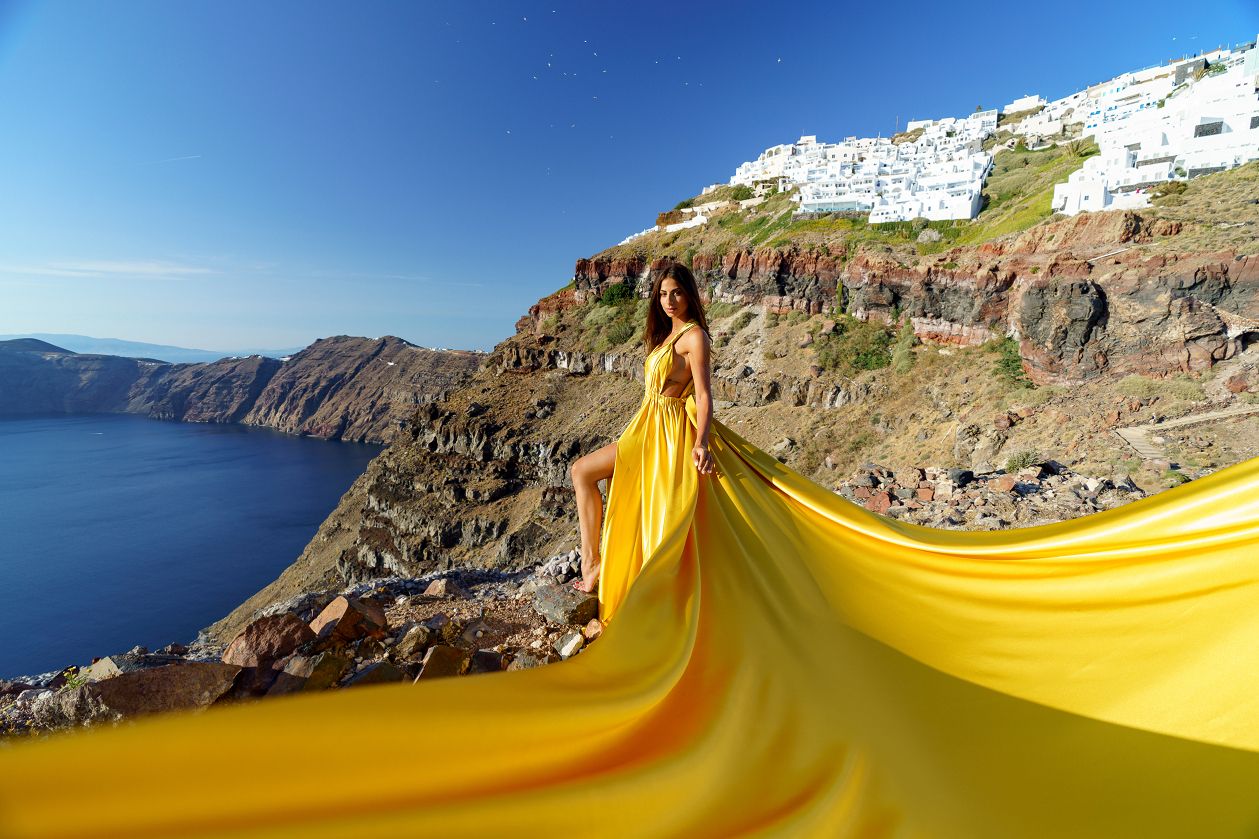 Yellow dress with caldera view in Santorini, Greece