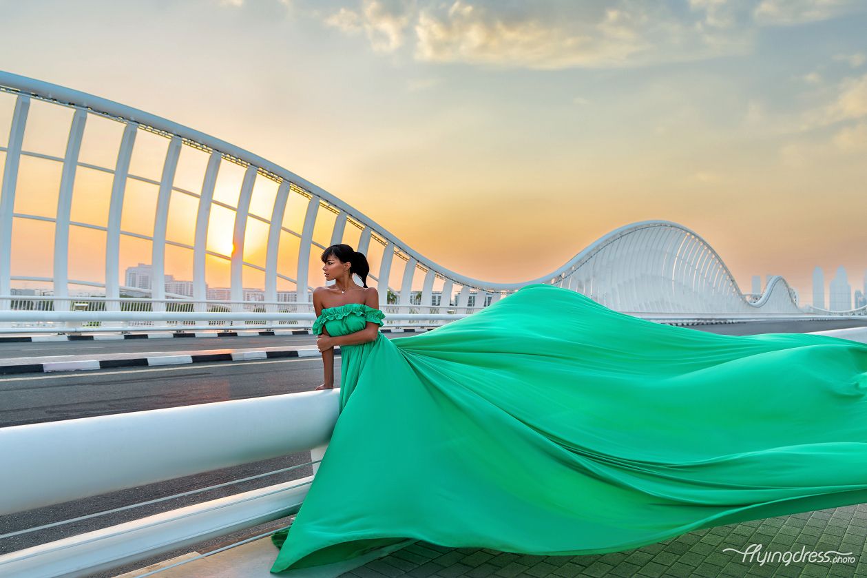 Chase the sun's farewell on Maydan Bridge with our model adorned in a striking green flying dress.