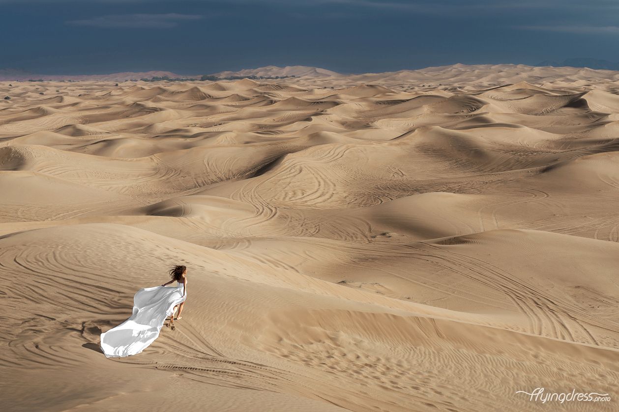 Capture the spirit of freedom as our model runs through the desert adorned in a flowing white flying dress.